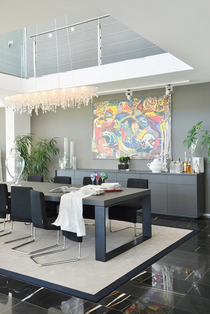 Black furniture below gallery in modern dining room