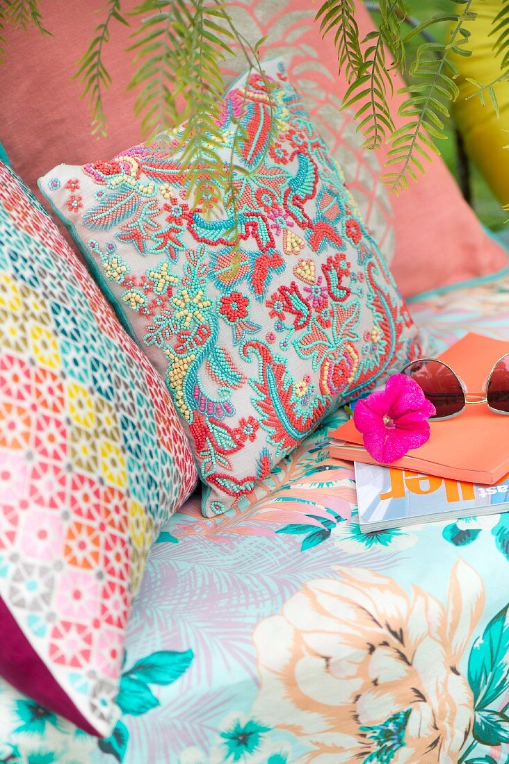 Colourful patterned cushions on seat