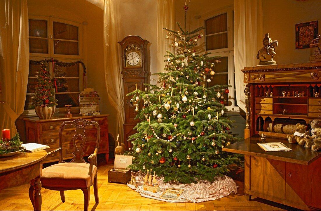 Christmas tree classically decorated and antique furniture in traditional interior