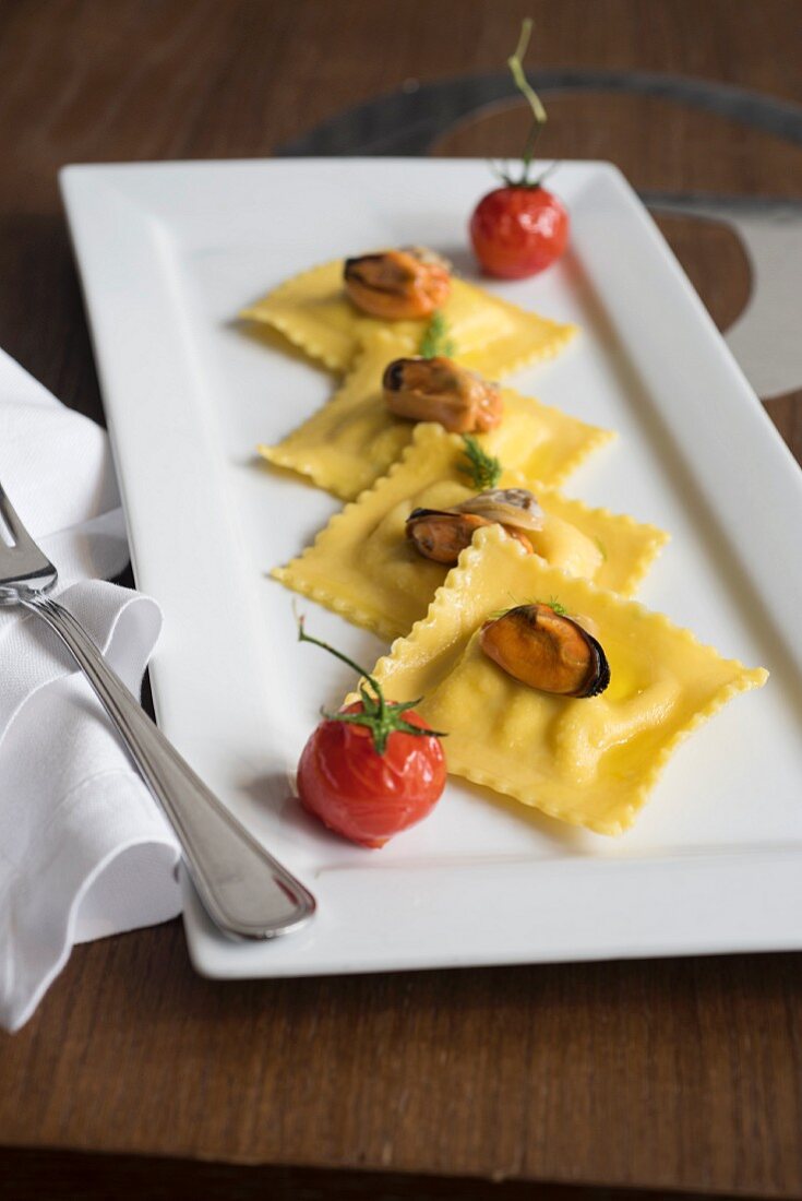 Branzini ravioli with mussels and braised tomatoes