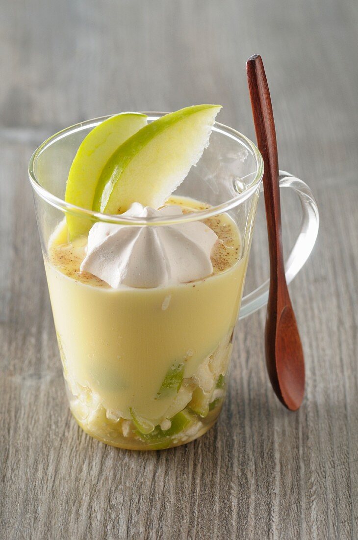Tiramisu with green apple and a dollop of meringue in a dessert glass