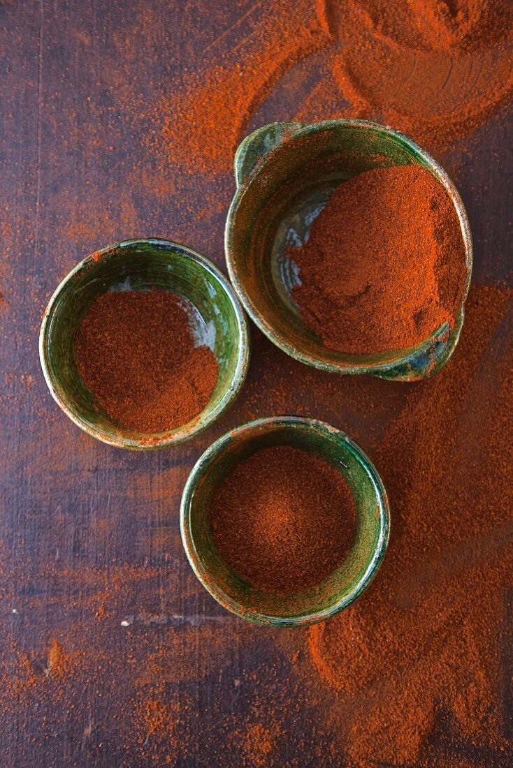Three bowls of chilli powder (seen from above)