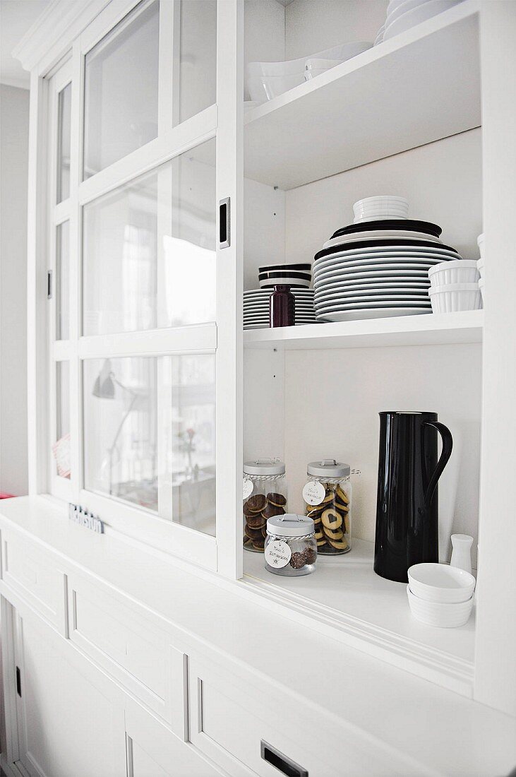 Black and white crockery in an open dresser