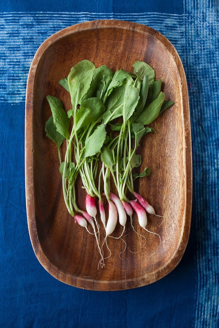 French baby radishes in a wooden bowl