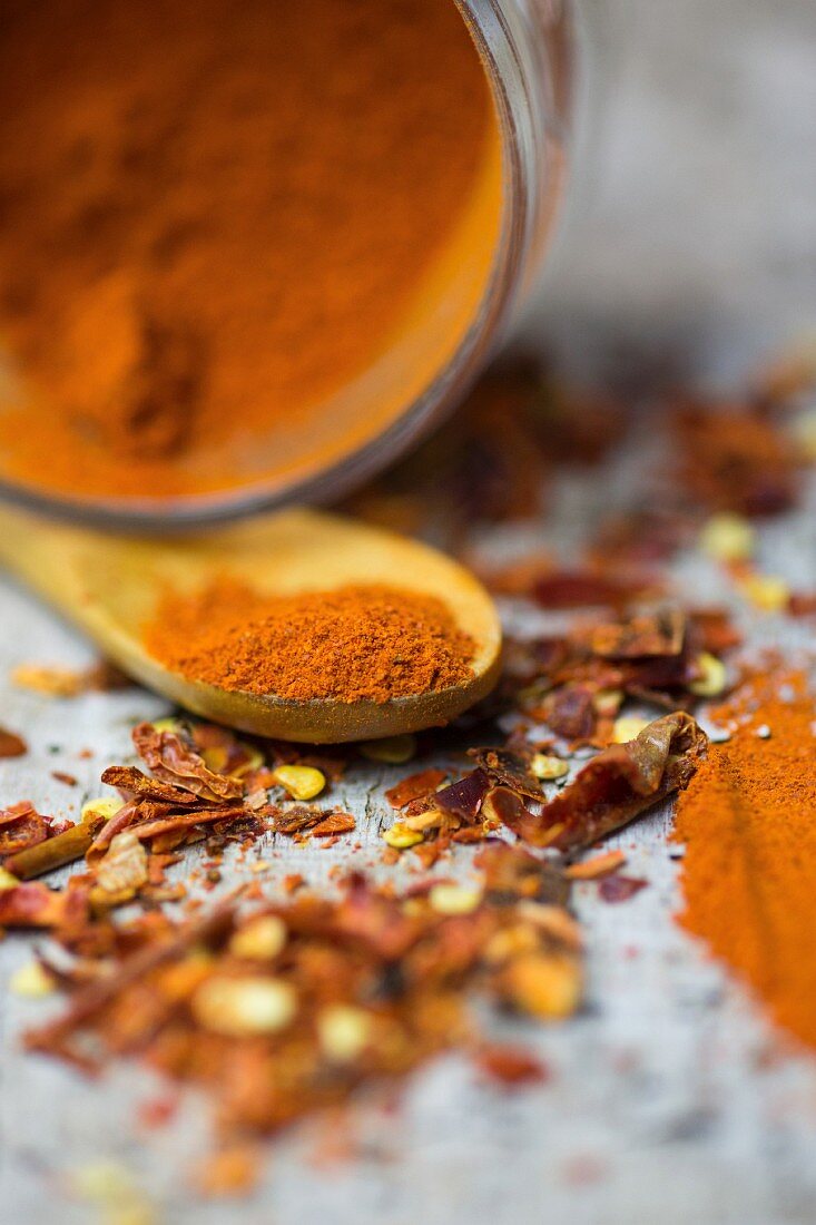 An arrangement of spices with chilli powder and chilli flakes