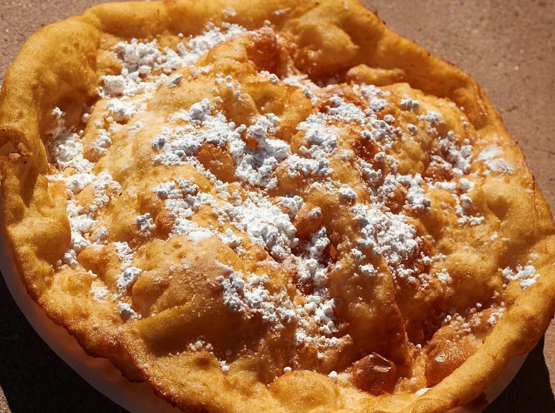 Frybread (USA) with icing sugar from a street market in Tucson, Arizona