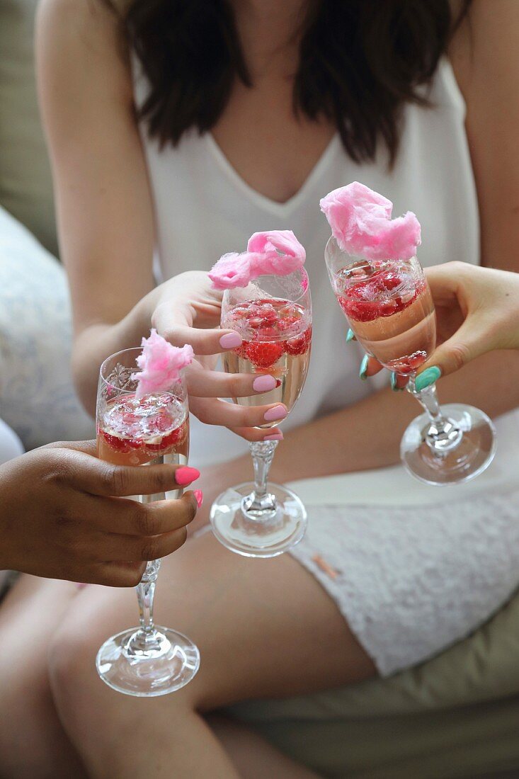 Sparkling wine with raspberries, pomegranate seeds and cotton candy