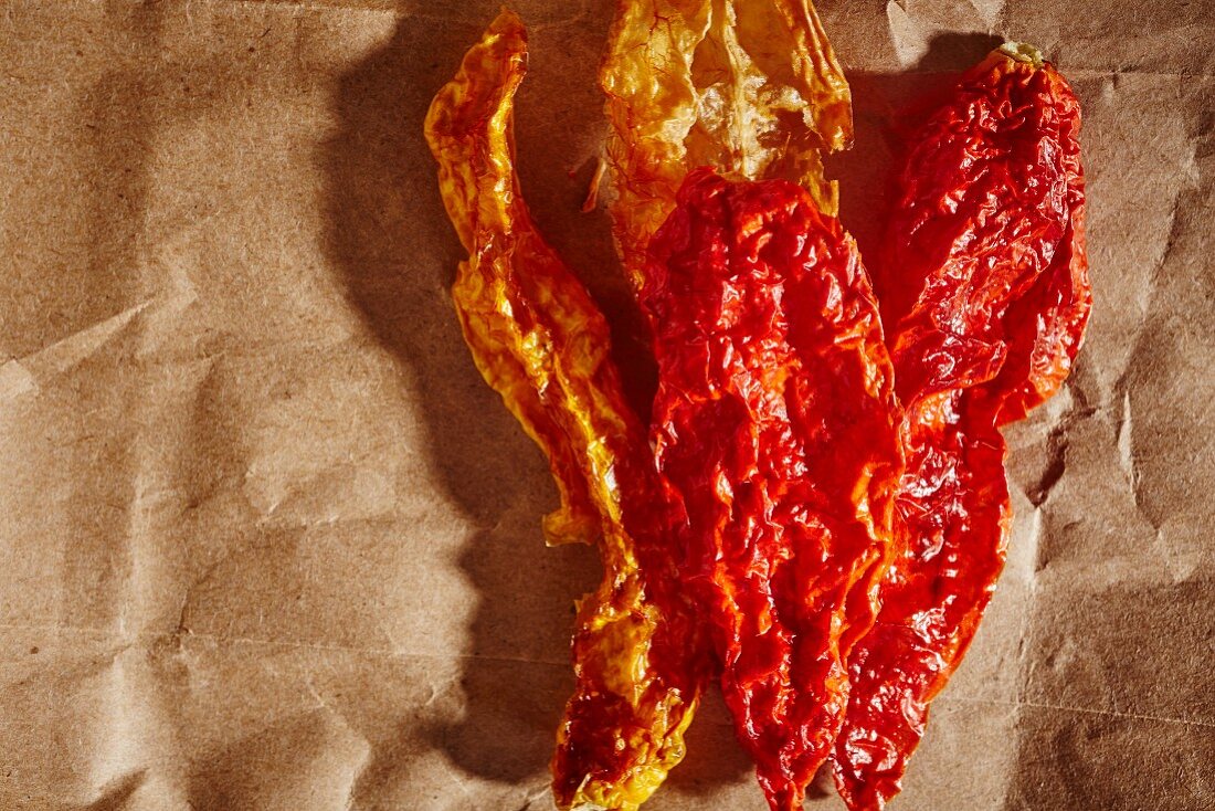 Dried chilli peppers on a piece of brown paper