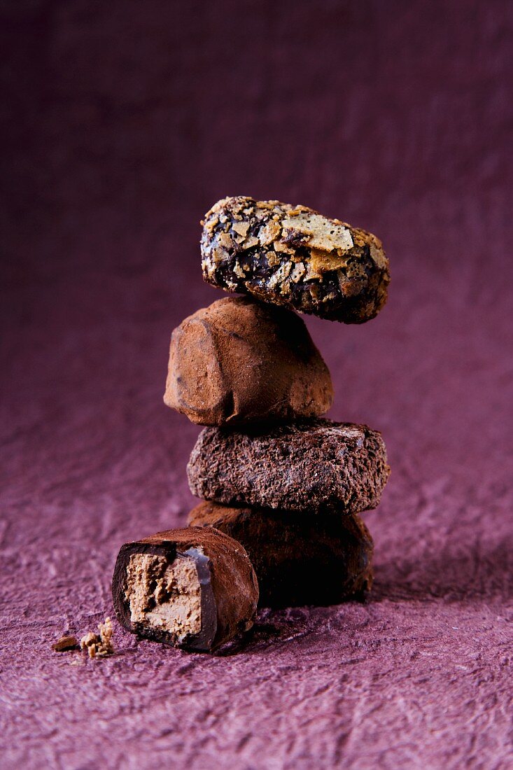 A stack of pralines on a purple surface