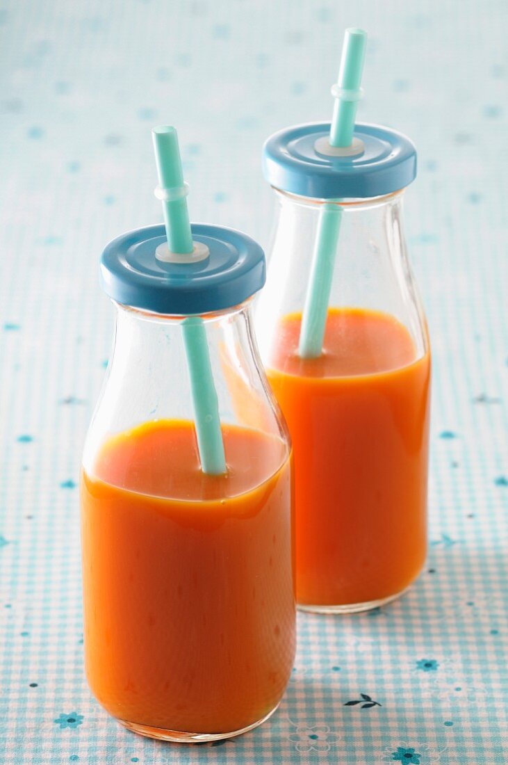 Carrot juice in glass bottles
