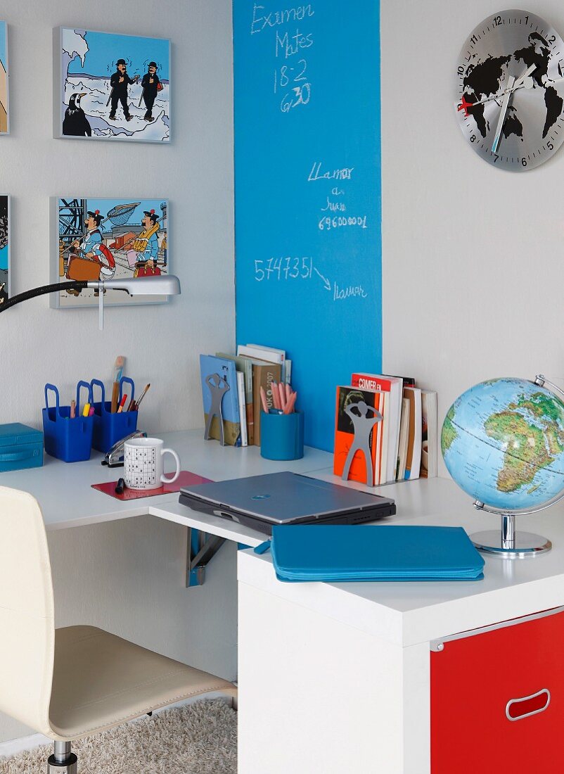 Folding table, cabinet and blue chalkboard stripe on wall in study area