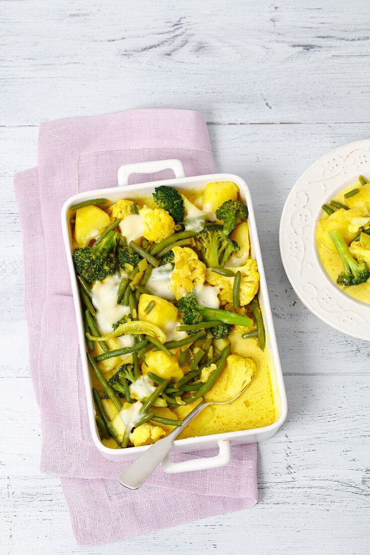 Vegetable bake with mozzarella and turmeric in a baking dish