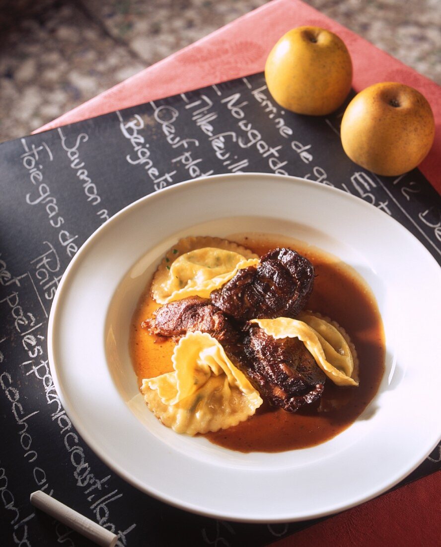 Beef in an apple wine sauce with ravioli
