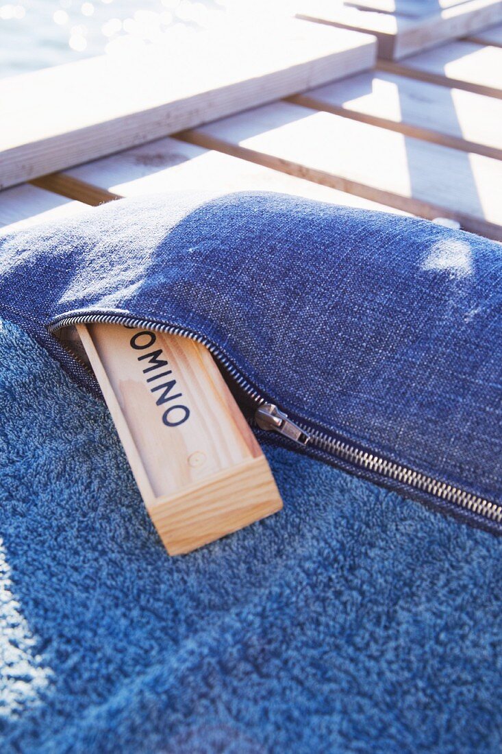 Beach towel with sewn-on denim pocket