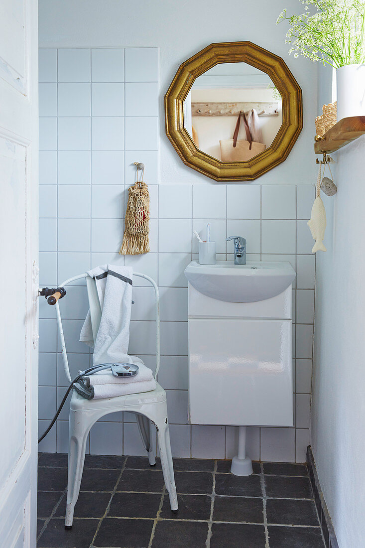 Metal stool in white bathroom