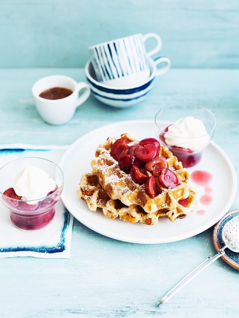 Waffles with cherry compote and whipped cream
