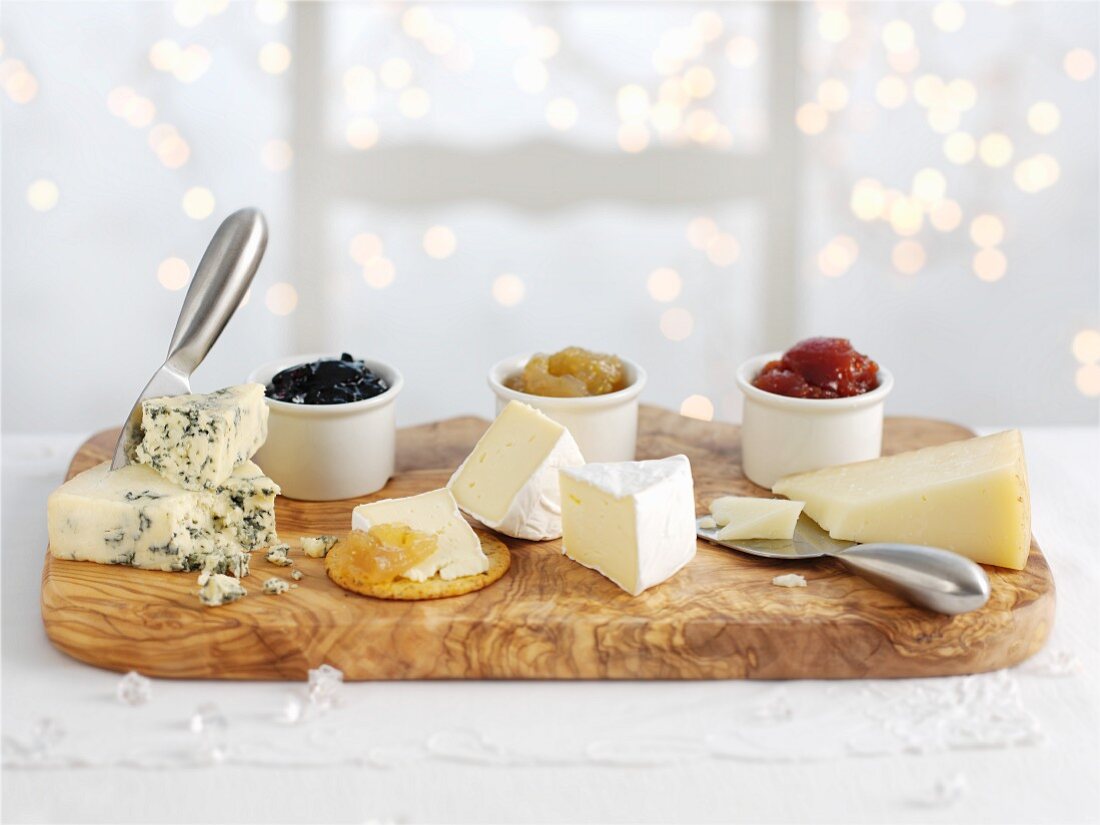 Three types of cheeses with accompanying chutneys