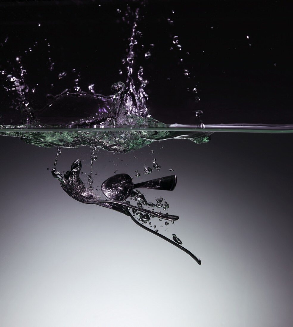 A spoon in water with a splash