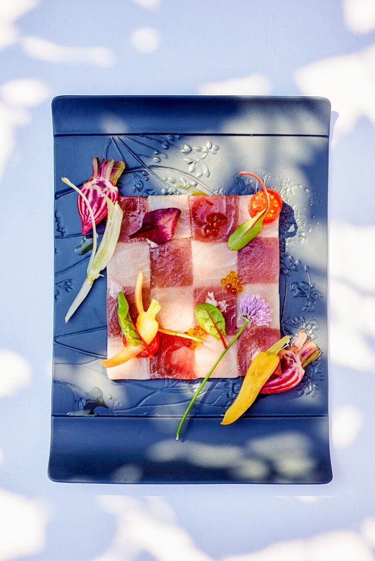 A tuna fish chessboard with spring vegetables