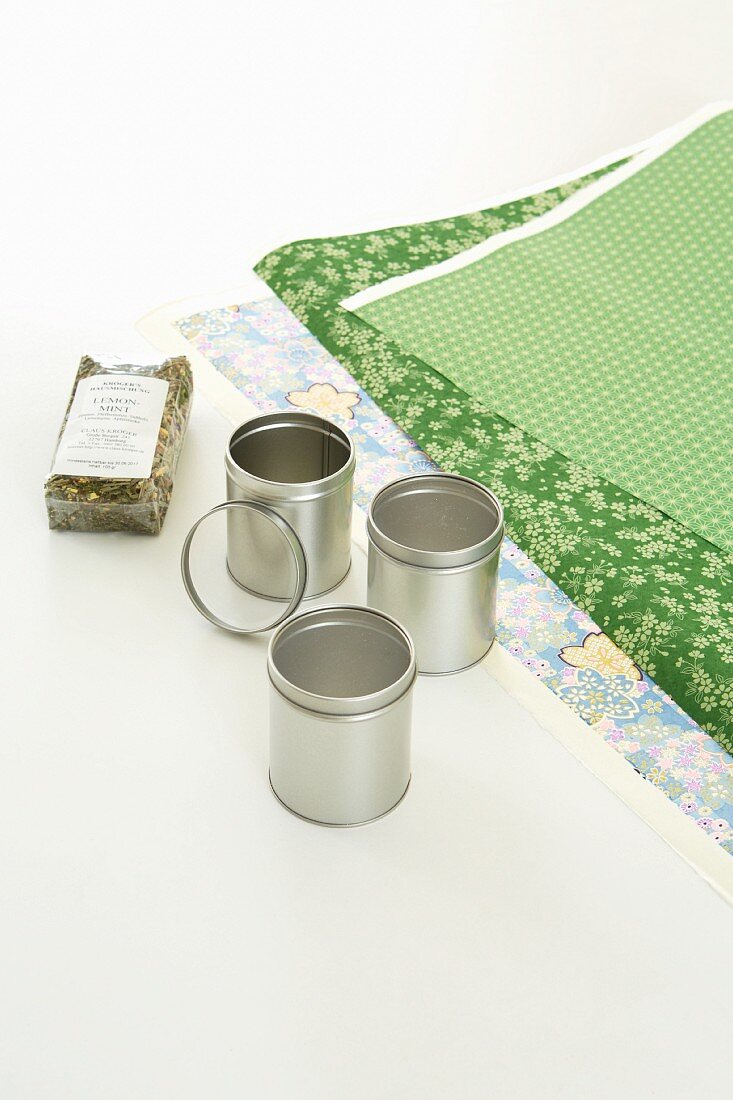 Presents being made: tea tins being covered in Japanese paper