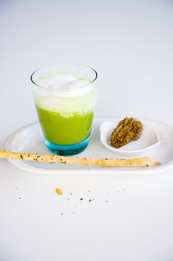 Herb foam cappuccino with stuffed morel mushrooms