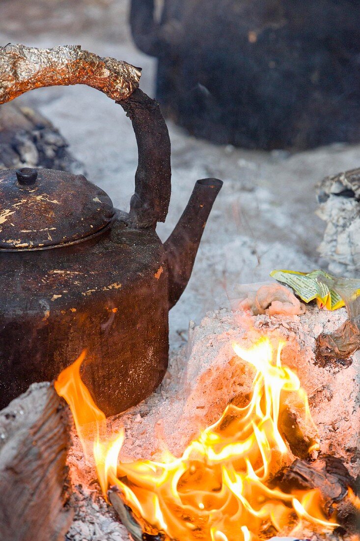 A kettle over an open fire