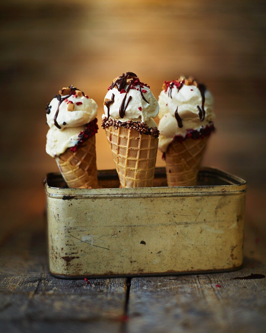 Vanilla ice-cream cones in a tin box on a wooden surface