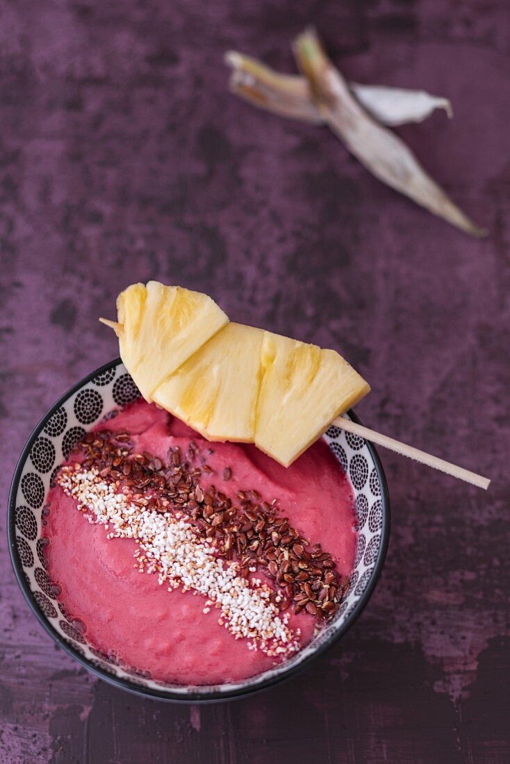 A smoothie bowl with pineapple and beetroot