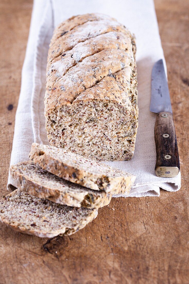 Spelt and wild garlic bread with flax seeds, sliced