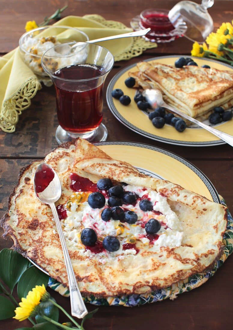 Vanilla crepes with blueberries, jam, cottage cheese and passion fruit