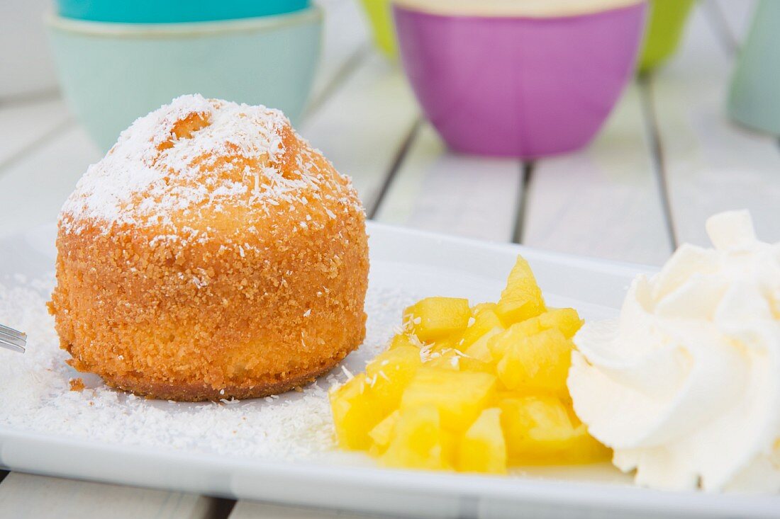 Coconut cake with fresh pineapple and whipped cream