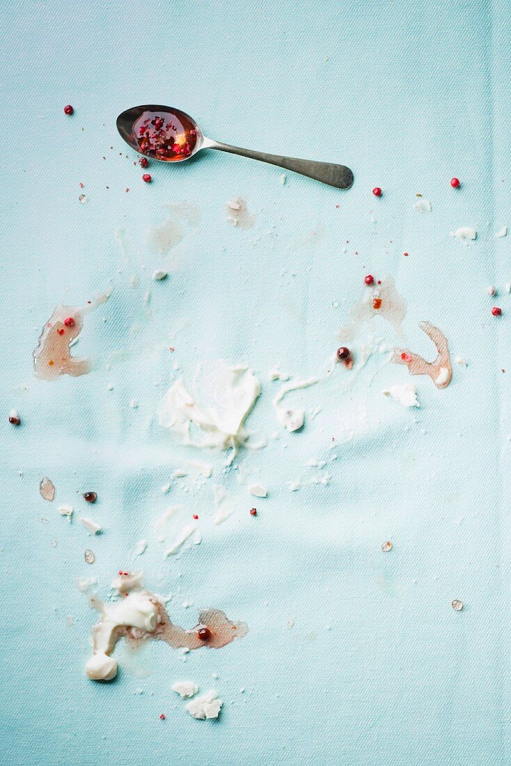 The remains of meringue on a pastel blue tablecloth