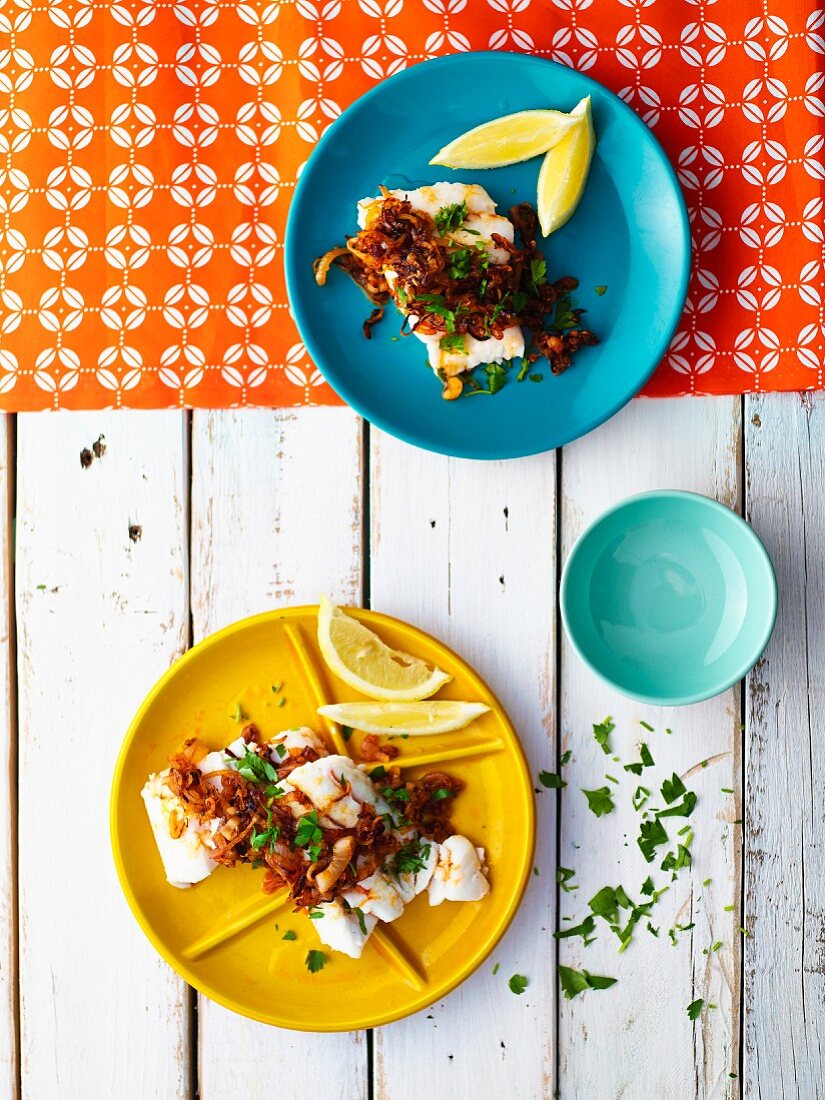 Poached hake with crispy pepper onions