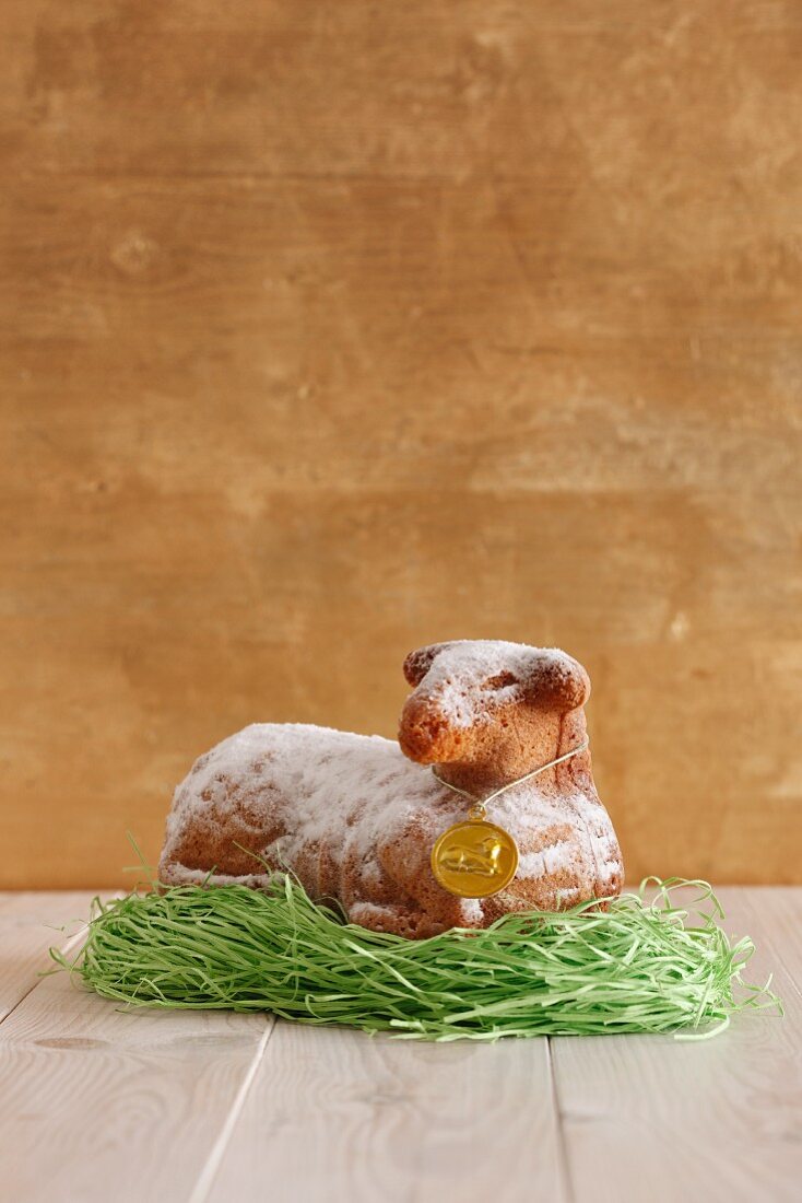 A baked Easter lamb on decorative grass