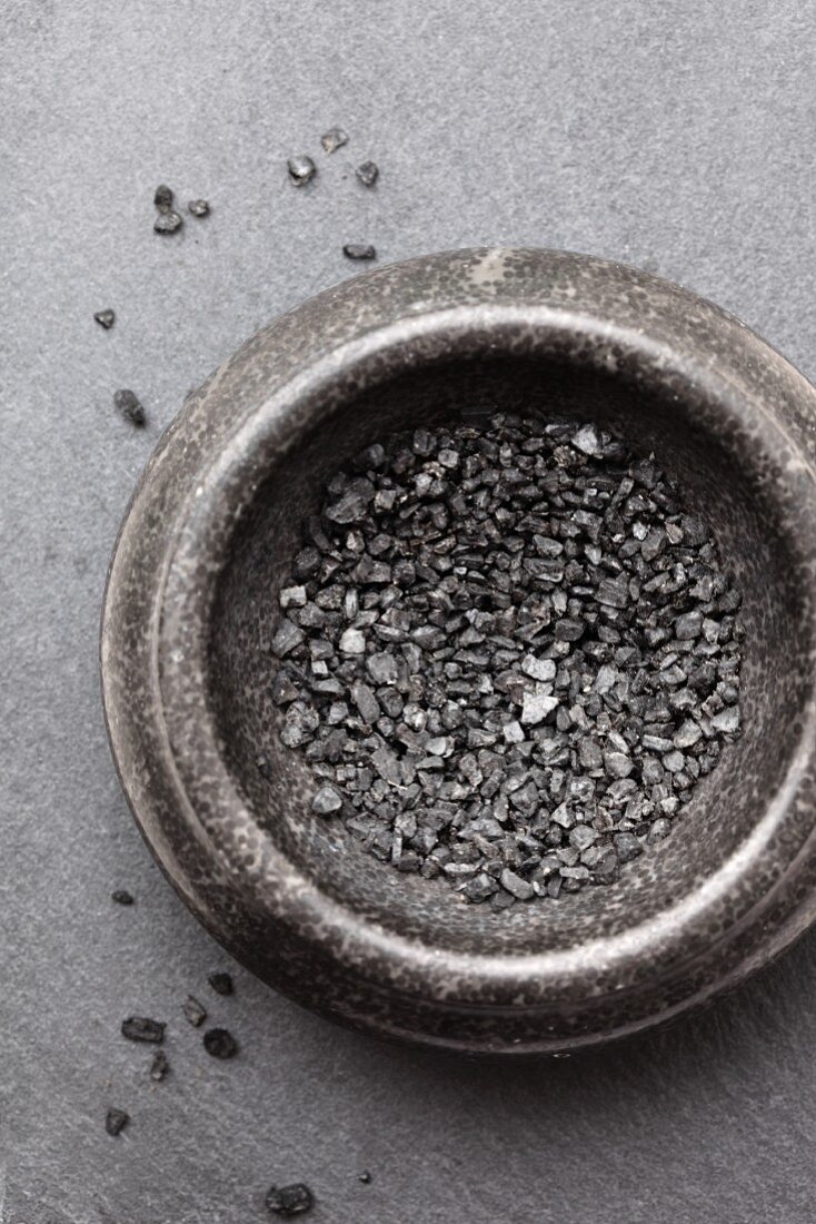 A bowl of black vulcan salt (seen from above)