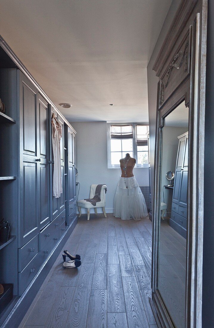 Fitted cupboards and tailors' dummy wearing skirt in hallway