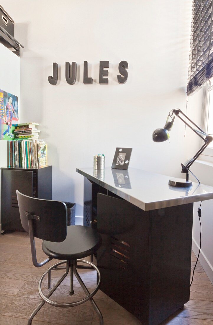 Teenager's bedroom in black and white with ornamental letters on wall