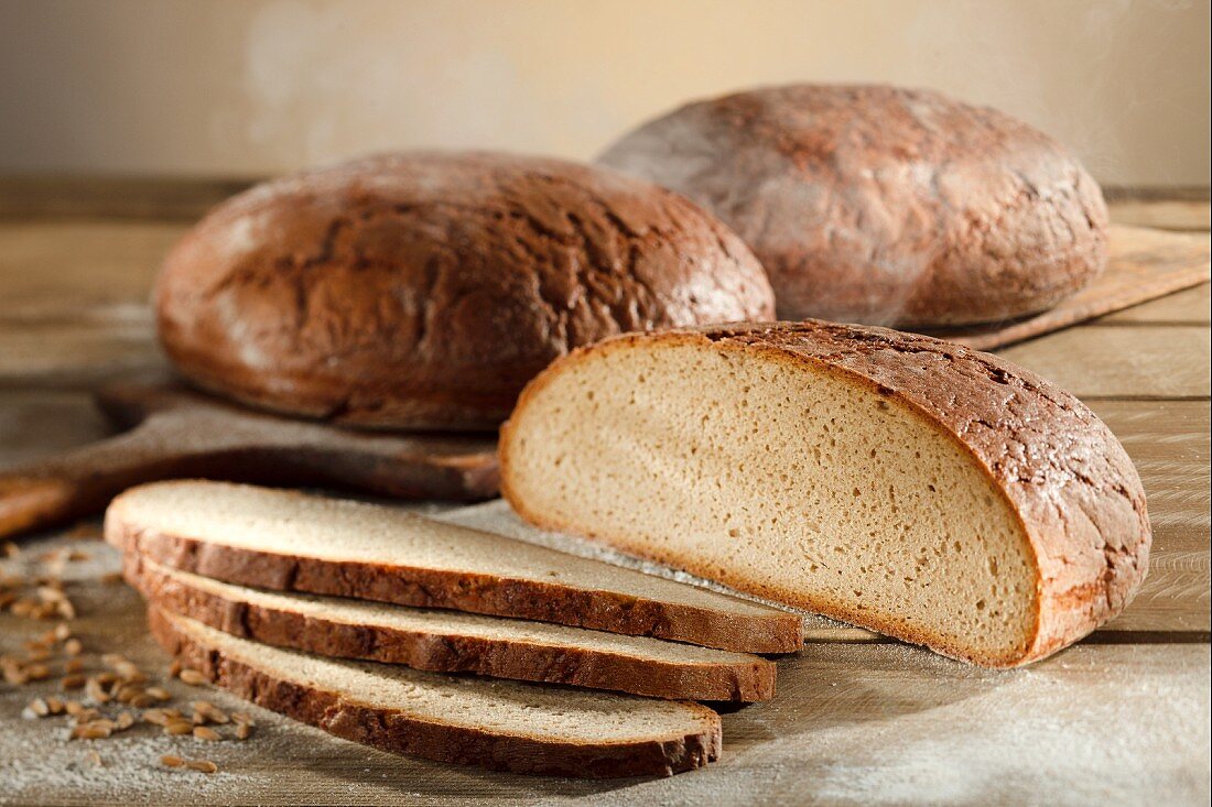 Three loaves of country bread (wheat and rye) with rye grains