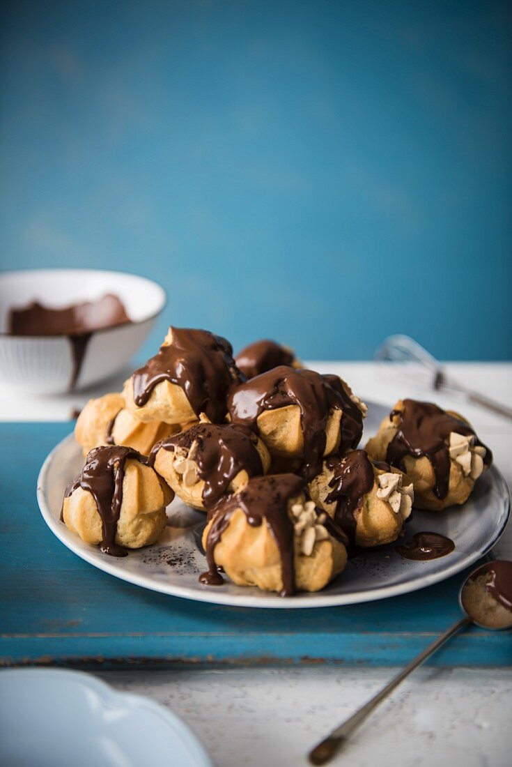 A plate of profiteroles with chocolate and coffee cream
