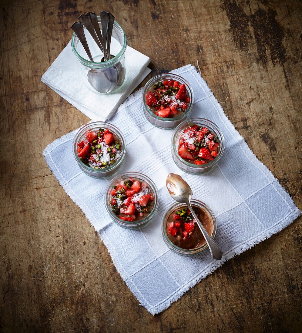Chocolate cream with strawberries and pistachio nuts in glasses