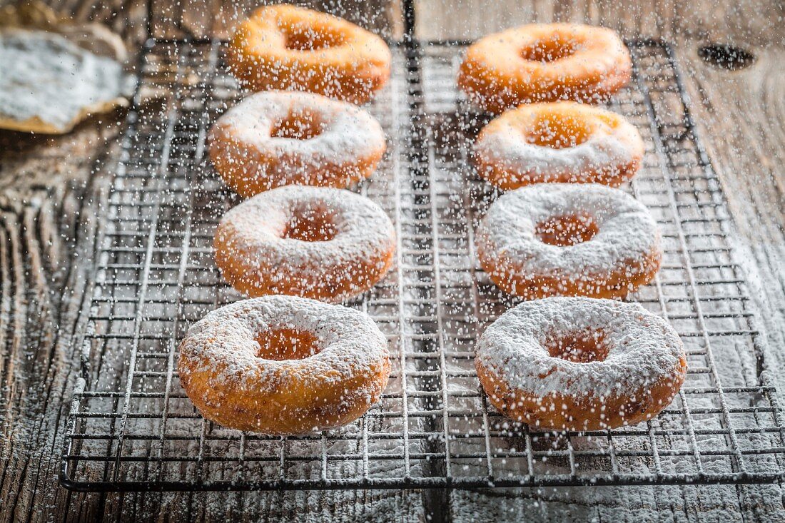 Freshly baked doughnuts dusted with icing sugar