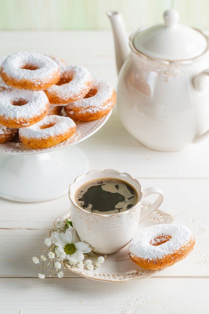 Doughnuts and coffee on a white table