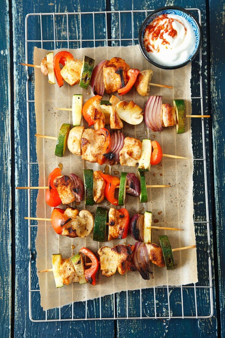 Chicken and vegetable skewers with a spicy yoghurt dip
