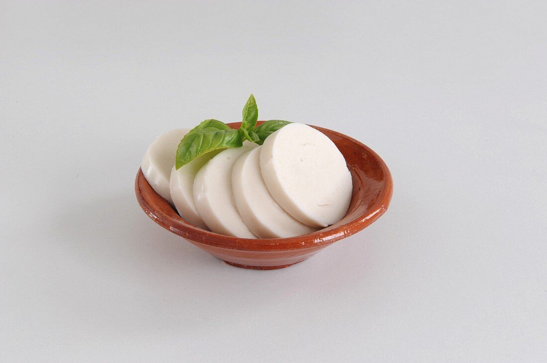 Vegan mozzarella in a clay bowl