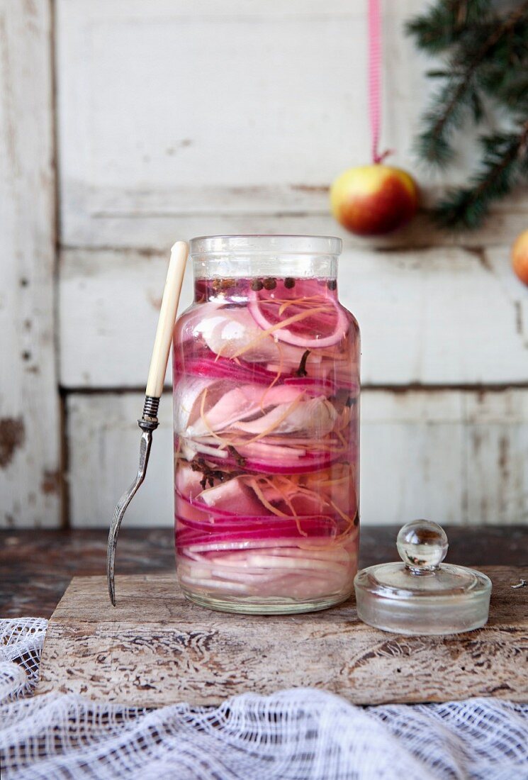 A jar of pickled herring with red onions