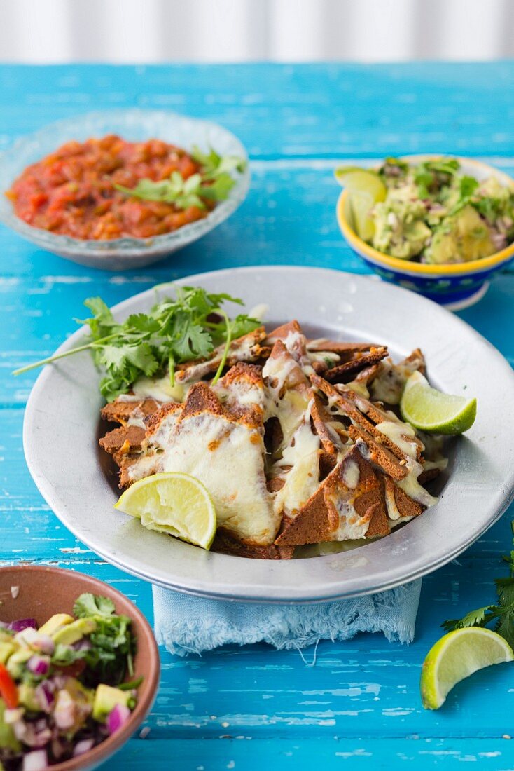 Homemade nachos with a trio of dips