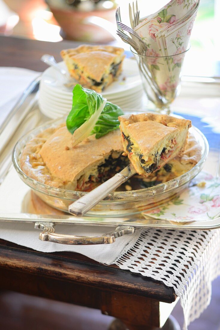 Chard pie with pine nuts on a table outside