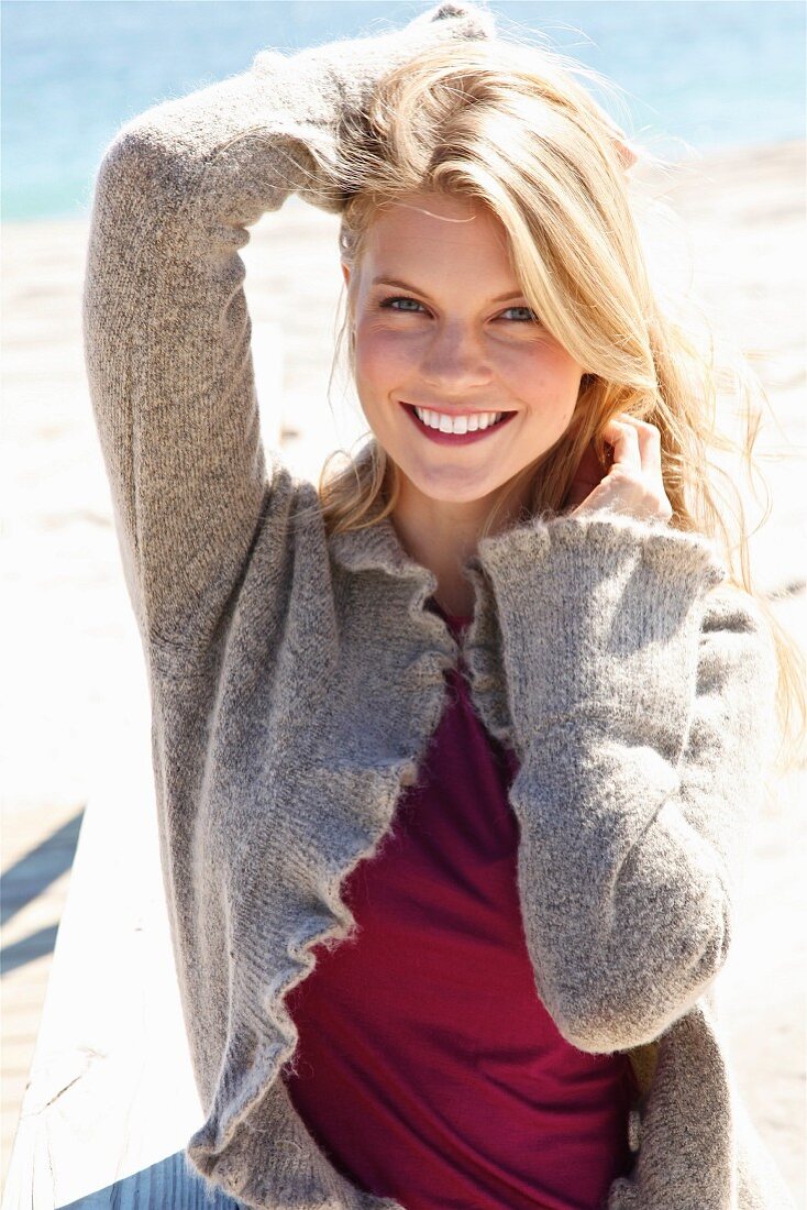 Young blonde woman wearing jeans and cardigan