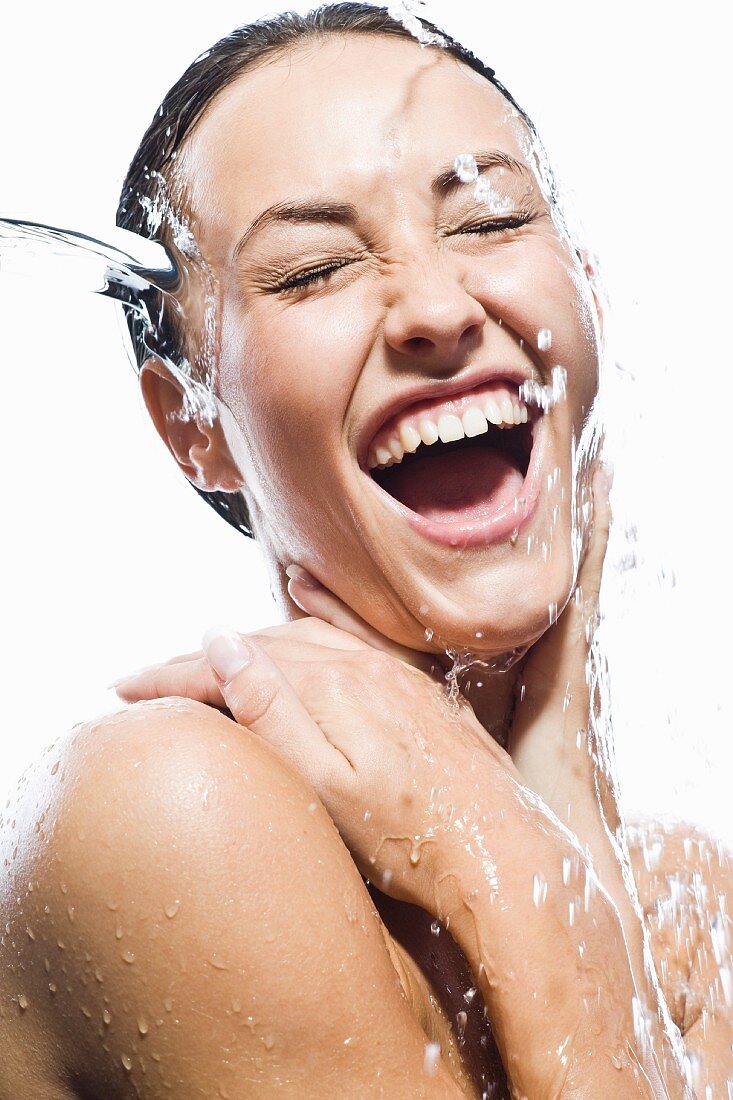 Topless woman under running shower