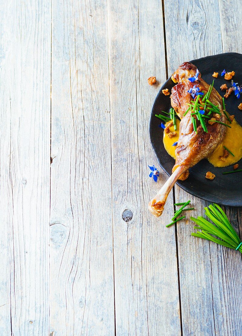 Spicy goose legs with crispy skin and borage flowers (Paleo)